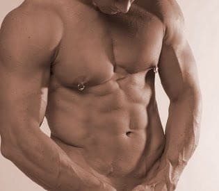 Close-up of a toned, muscular male torso with two pierced nipples, shot in warm sepia lighting